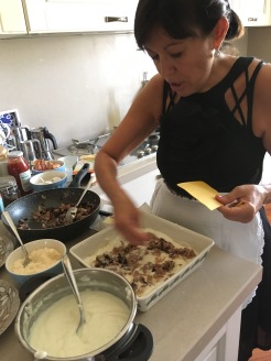 Maria assembles lasagne